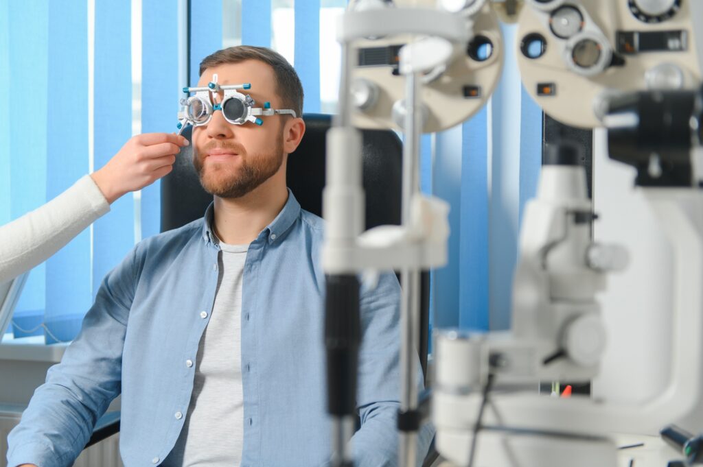 Male patient under eye vision examination in eyesight ophthalmological correction clinic