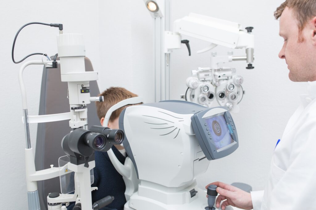 Optician testing a boy's eyes